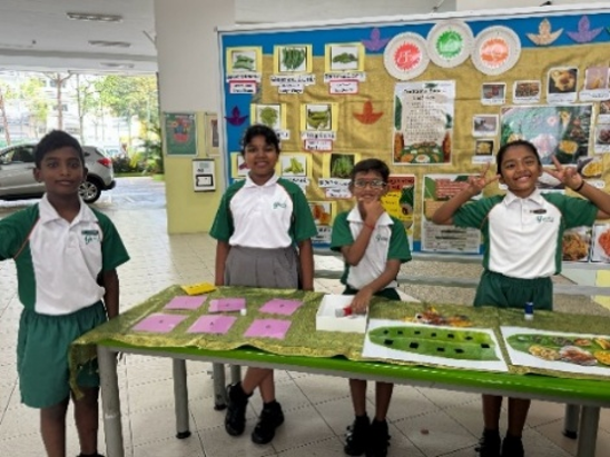 Students presenting their Tamil language project at a school exhibition.